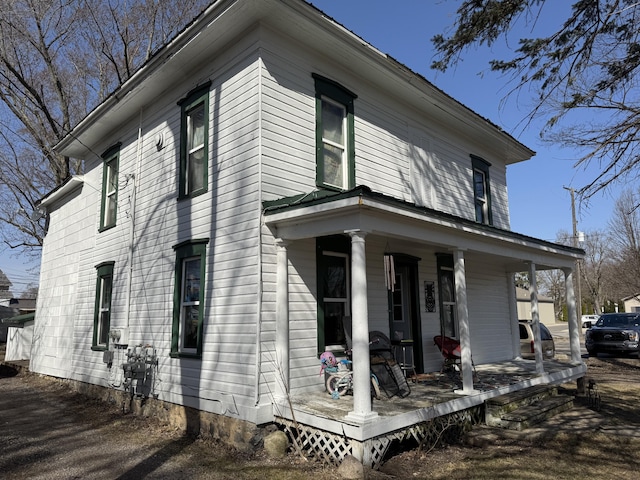 view of side of home with covered porch