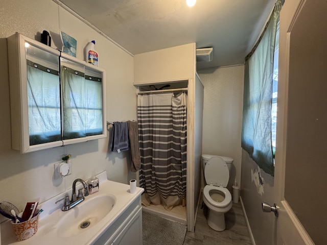 full bath with a shower with shower curtain, toilet, vanity, and wood finished floors