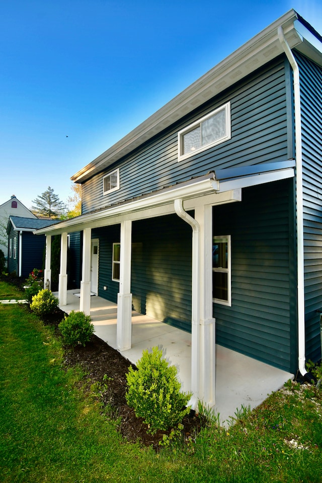 back of property featuring a yard and a patio area
