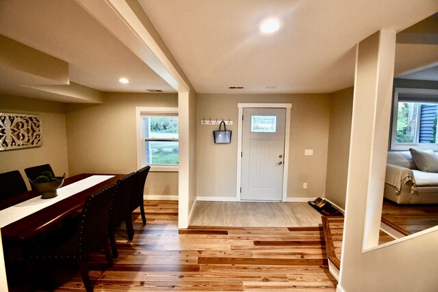 entrance foyer with wood finished floors, plenty of natural light, baseboards, and recessed lighting