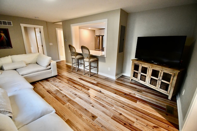 living area with wood finished floors and baseboards