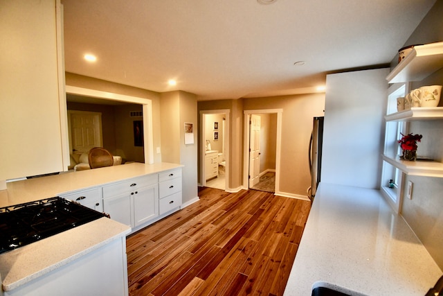 kitchen featuring white cabinets, dark wood finished floors, open shelves, recessed lighting, and light stone countertops