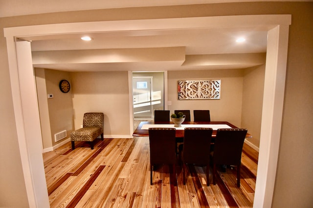 dining area featuring light wood finished floors, baseboards, and recessed lighting