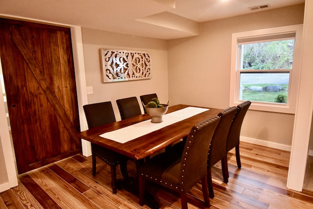 dining area featuring wood finished floors and baseboards