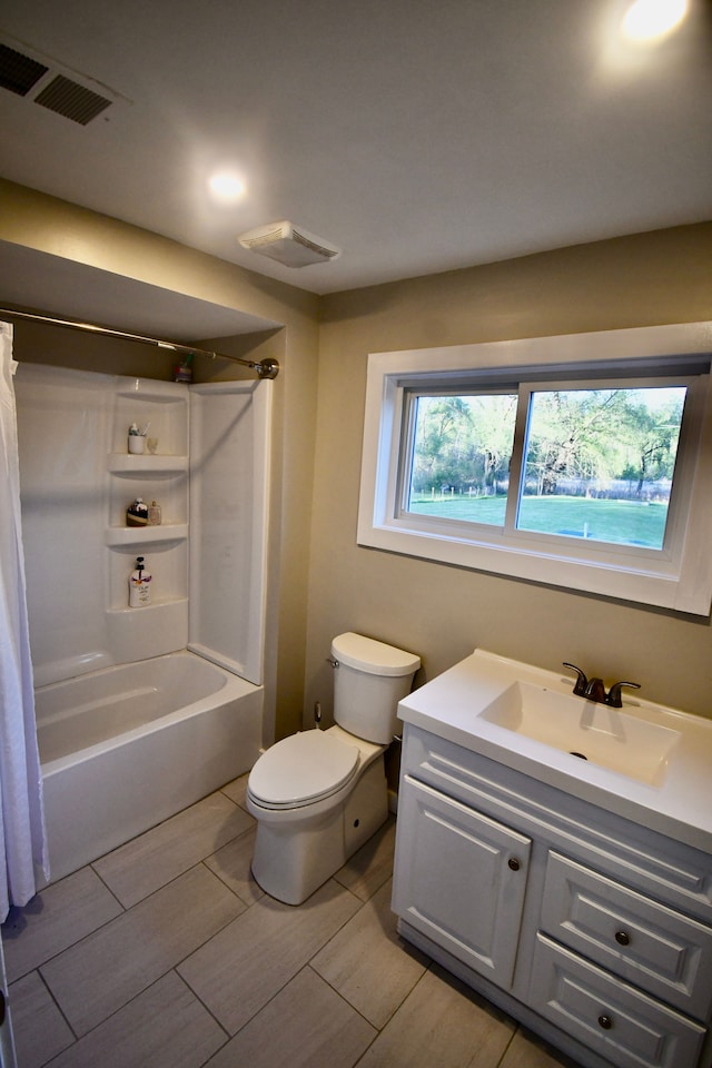 full bathroom featuring toilet, vanity, and shower / tub combo