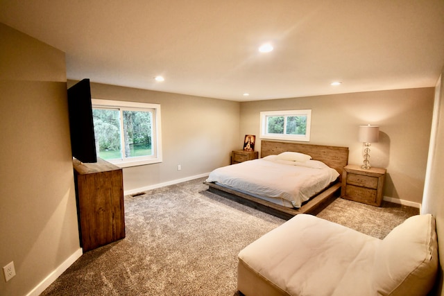 carpeted bedroom featuring baseboards, multiple windows, and recessed lighting