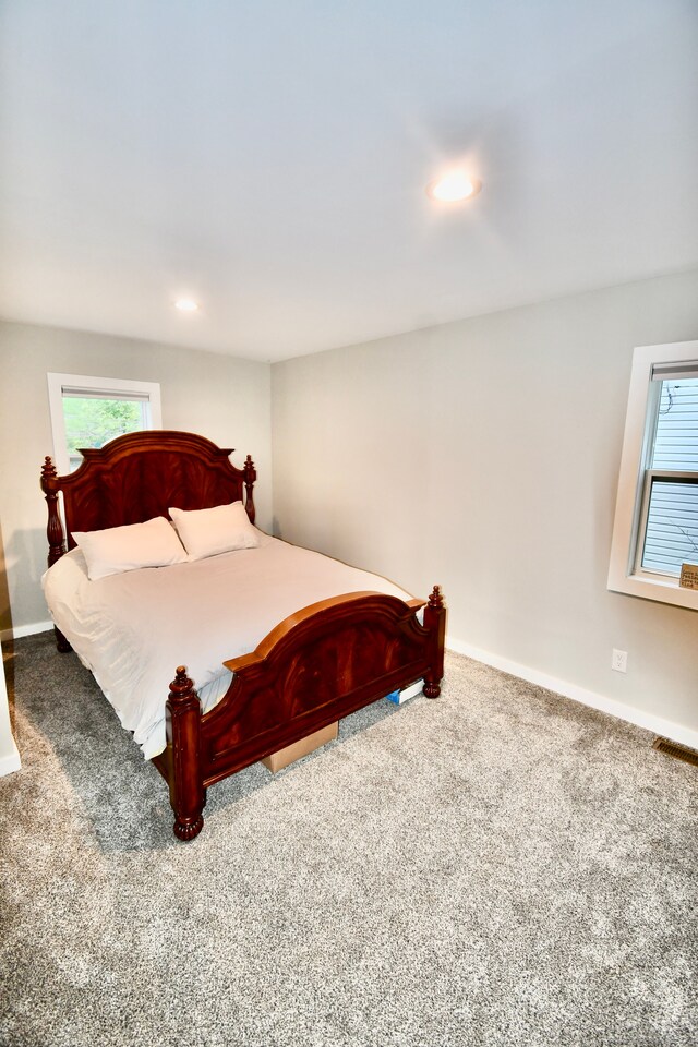 carpeted bedroom featuring multiple windows, baseboards, and recessed lighting