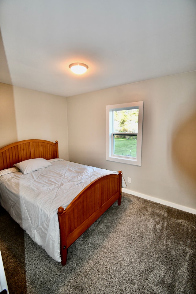 bedroom featuring carpet flooring and baseboards