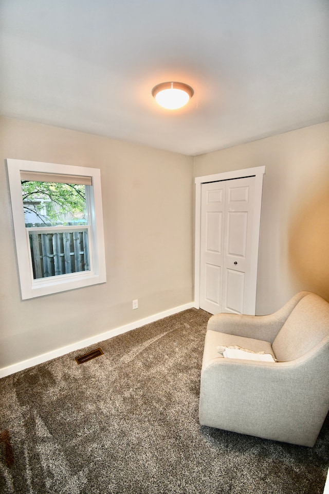 sitting room with carpet and baseboards
