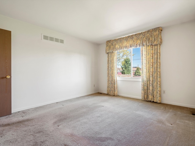 carpeted spare room with baseboards