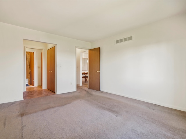 unfurnished room with carpet and baseboards
