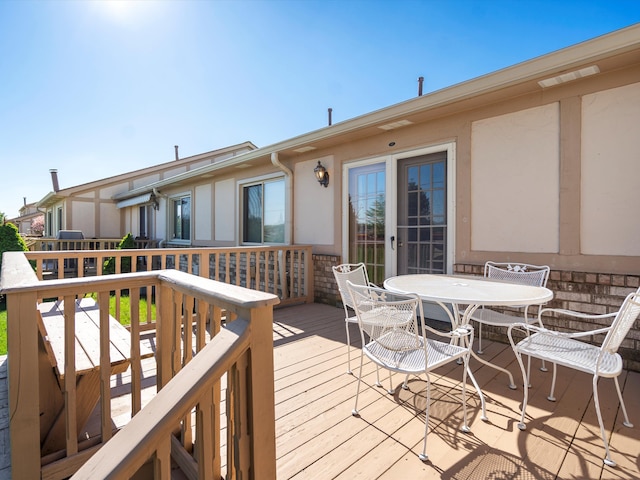 wooden deck featuring outdoor dining area