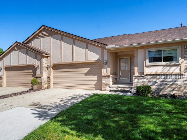 view of front of house featuring an attached garage, brick siding, concrete driveway, a front yard, and roof with shingles