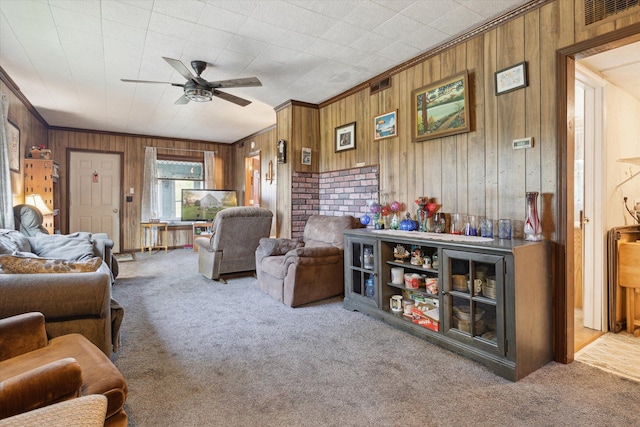 12948 Peck Ave, Sawyer, MI 49125 - carpeted living area with ceiling fan, wood walls, and ornamental molding
