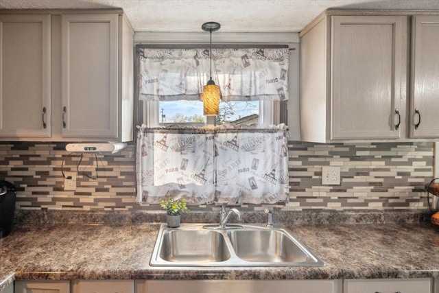 12948 Peck Ave, Sawyer, MI 49125 - kitchen featuring a sink, dark countertops, and tasteful backsplash