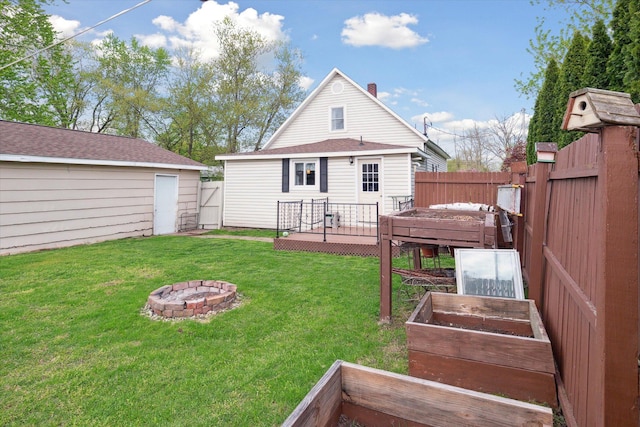 12948 Peck Ave, Sawyer, MI 49125 - back of property featuring a garden, a fire pit, and a deck