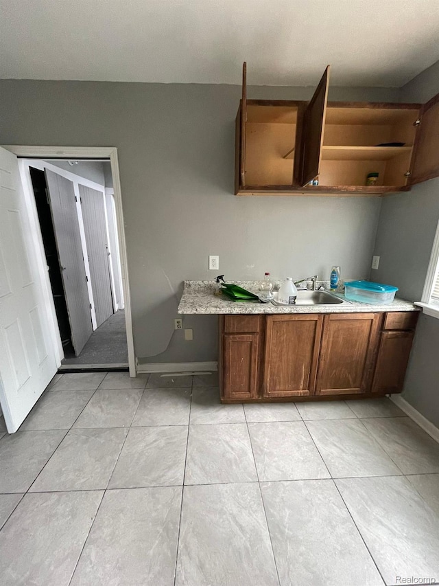 7910 Wetherby St, Detroit, MI 48210 - kitchen with open shelves, light countertops, and light tile patterned floors