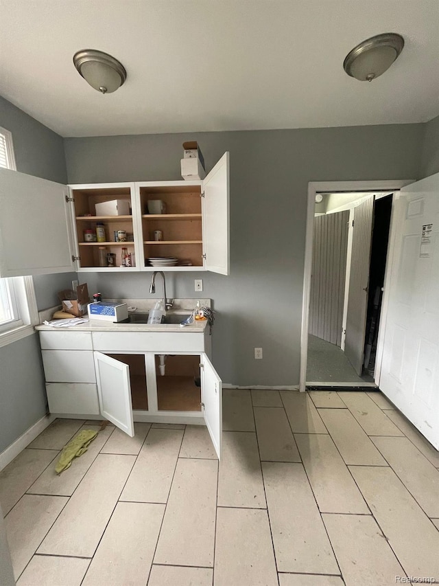 7910 Wetherby St, Detroit, MI 48210 - kitchen with open shelves, white cabinets, and light tile patterned floors