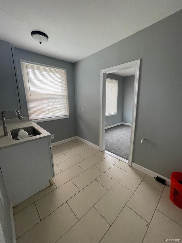 7910 Wetherby St, Detroit, MI 48210 - unfurnished dining area with a sink and light tile patterned floors