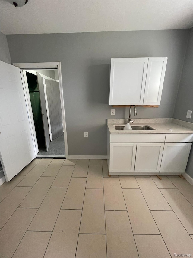 7910 Wetherby St, Detroit, MI 48210 - kitchen with white cabinetry, light countertops, and light tile patterned flooring