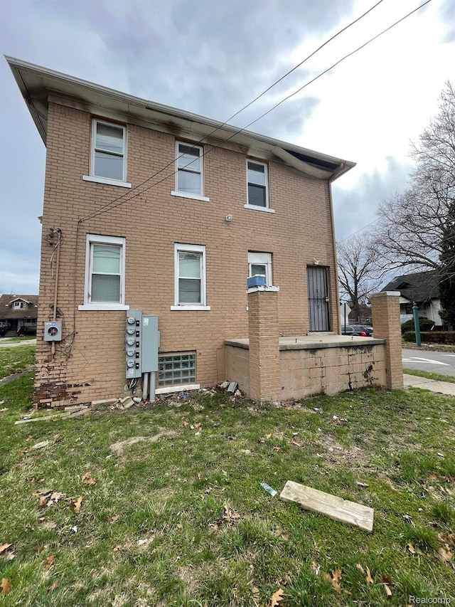 7910 Wetherby St, Detroit, MI 48210 - back of property with brick siding and a yard