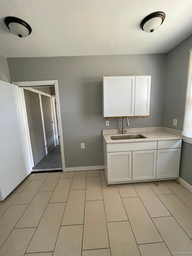 7910 Wetherby St, Detroit, MI 48210 - kitchen featuring white cabinetry, light countertops, and light tile patterned flooring
