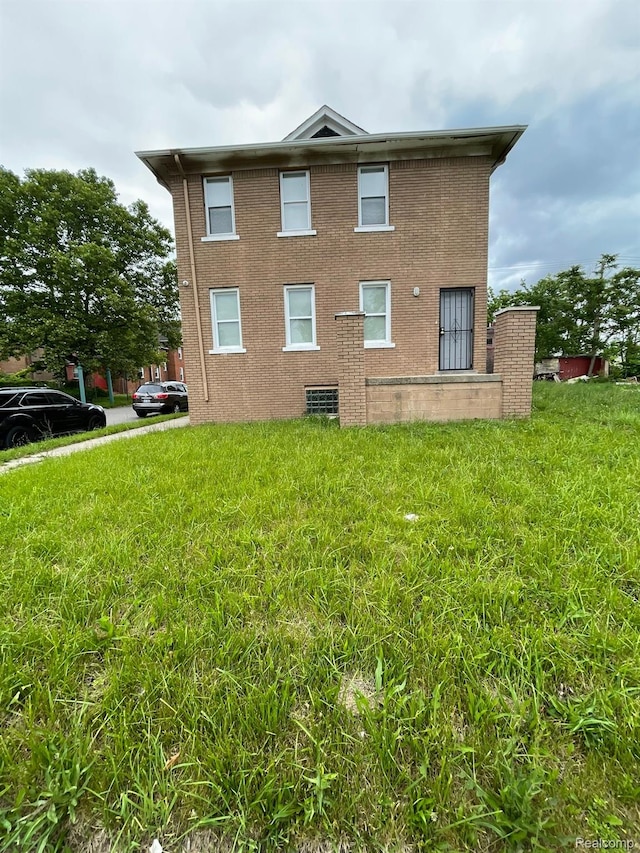 7910 Wetherby St, Detroit, MI 48210 - view of side of home with brick siding and a yard