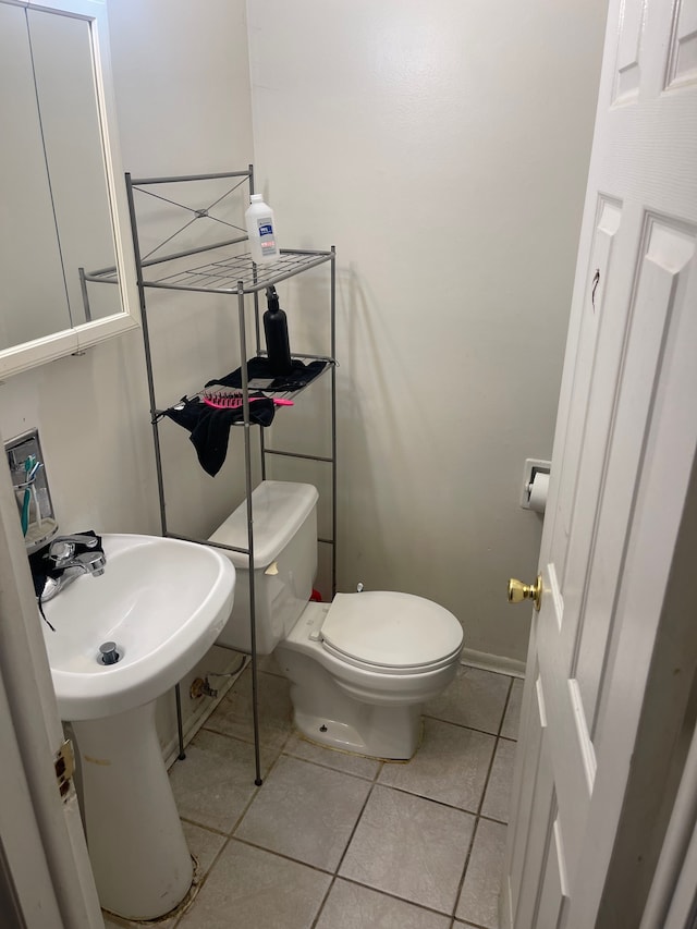 20225 Ledgestone St, Southfield, MI 48076 - bathroom featuring tile patterned flooring, toilet, a sink, and baseboards