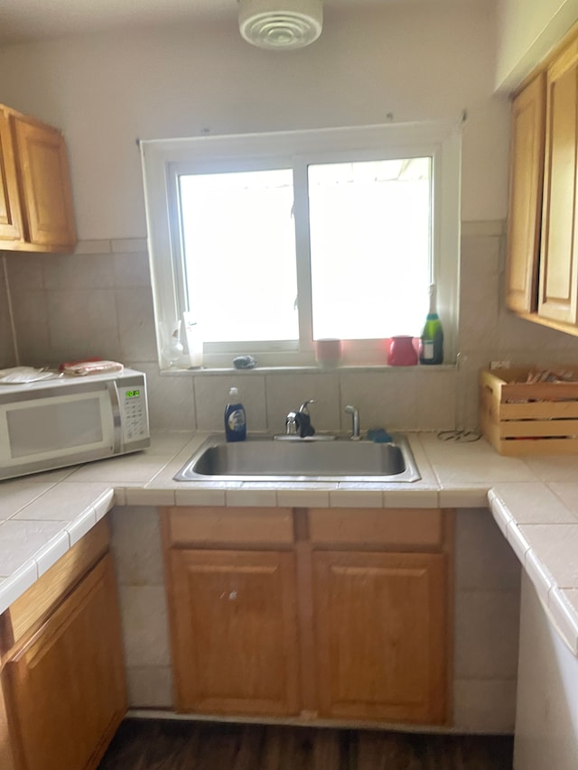 20225 Ledgestone St, Southfield, MI 48076 - kitchen with white microwave, a sink, and tile counters