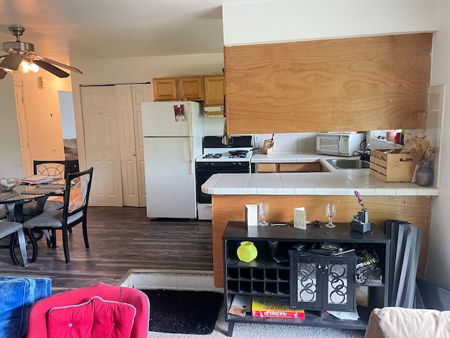 20225 Ledgestone St, Southfield, MI 48076 - kitchen with white appliances, tile countertops, ceiling fan, dark wood-style flooring, and a sink