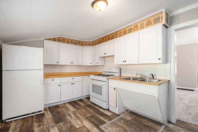 kitchen featuring white appliances, a sink, white cabinetry, dark wood-style floors, and vaulted ceiling
