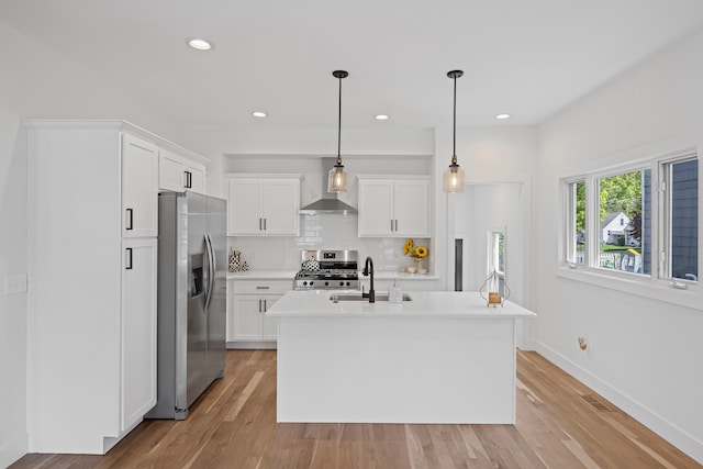 kitchen featuring stainless steel appliances, light countertops, white cabinetry, tasteful backsplash, and a sink