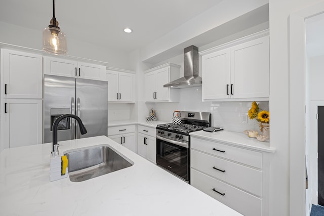 kitchen with wall chimney exhaust hood, stainless steel appliances, a sink, white cabinetry, and hanging light fixtures