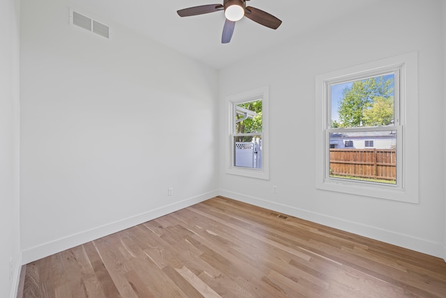 unfurnished room featuring baseboards, wood finished floors, and a ceiling fan