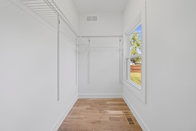 spacious closet with light wood finished floors