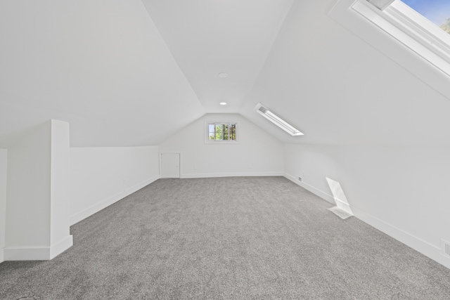 bonus room featuring lofted ceiling, carpet flooring, and baseboards