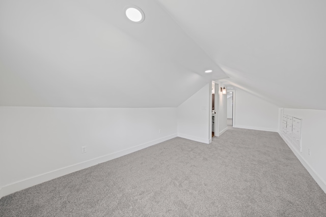 additional living space featuring lofted ceiling, carpet, and baseboards