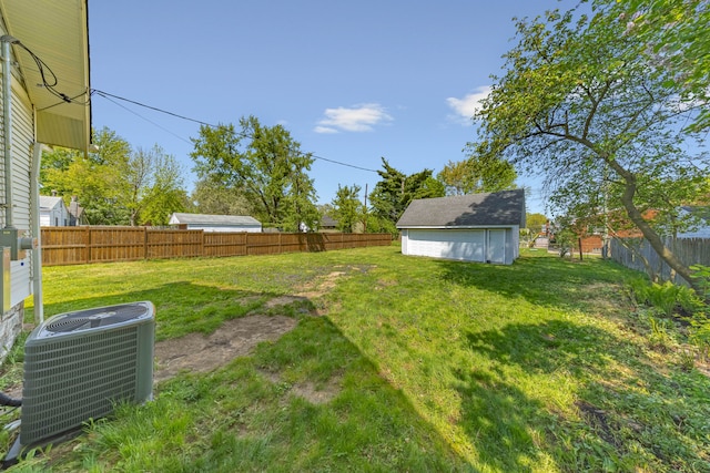 view of yard with central AC and a garage