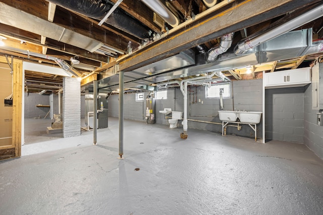 below grade area with gas water heater, heating unit, and a sink