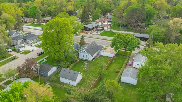 aerial view of residential area featuring a forest