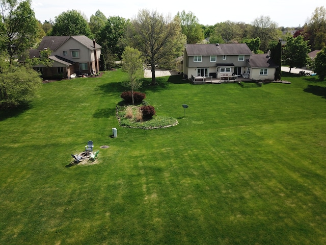 41315 Carriage Hill Dr, Novi, MI 48375 - view of grassy yard featuring a wooden deck and an outdoor fire pit