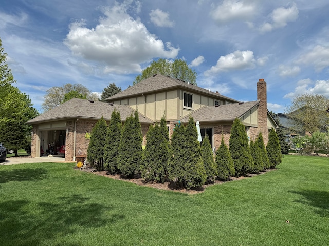 41315 Carriage Hill Dr, Novi, MI 48375 - view of home's exterior with a yard, brick siding, a chimney, and roof with shingles