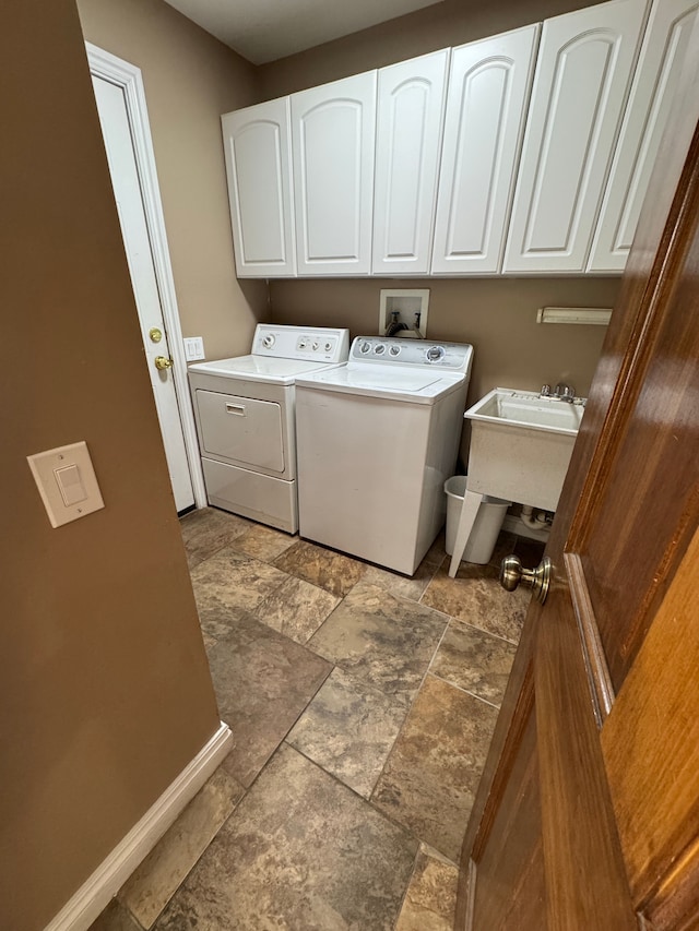 41315 Carriage Hill Dr, Novi, MI 48375 - laundry room featuring washing machine and clothes dryer, dark stone finish floors, cabinet space, and baseboards