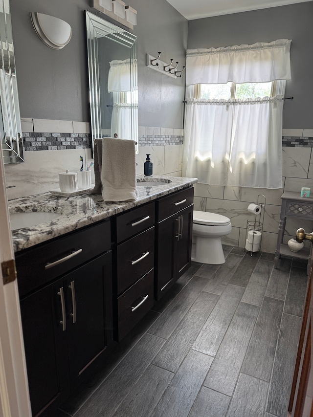 41315 Carriage Hill Dr, Novi, MI 48375 - full bath with tile walls, toilet, double vanity, wainscoting, and wood finish floors
