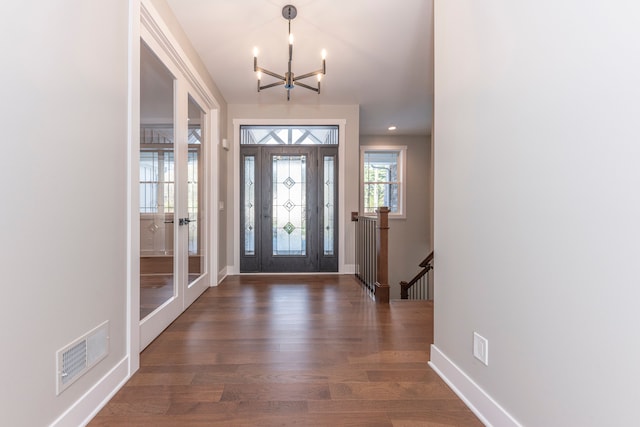 5535 W Huron River Dr, Dexter, MI 48130 - foyer with french doors, a chandelier, wood finished floors, and baseboards