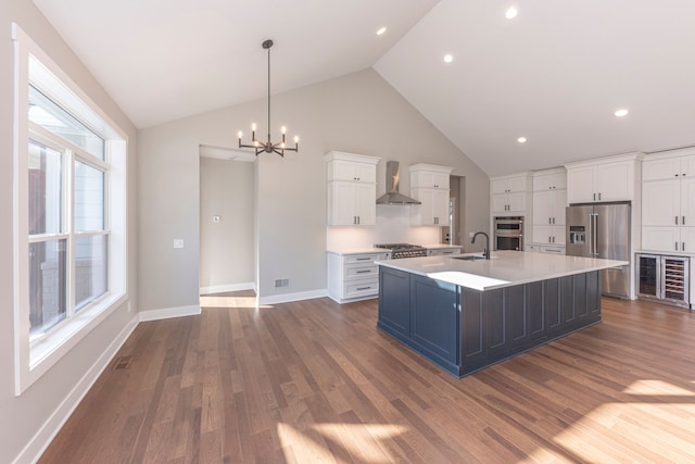 5535 W Huron River Dr, Dexter, MI 48130 - kitchen featuring stainless steel appliances, wall chimney exhaust hood, a sink, wine cooler, and a chandelier