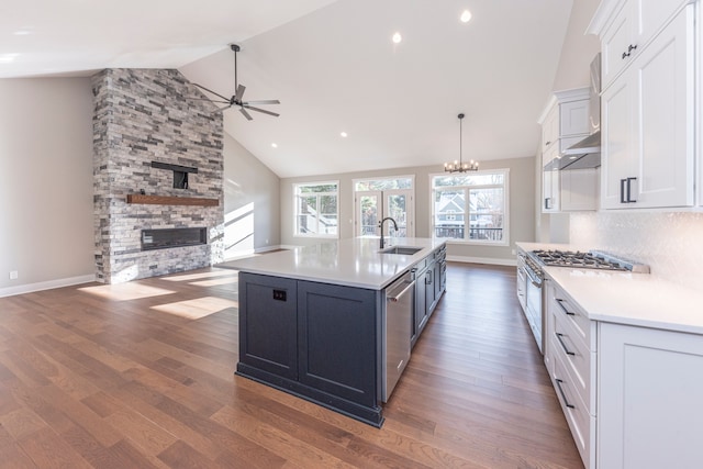 5535 W Huron River Dr, Dexter, MI 48130 - kitchen with a sink, ceiling fan, white cabinets, light countertops, and high vaulted ceiling
