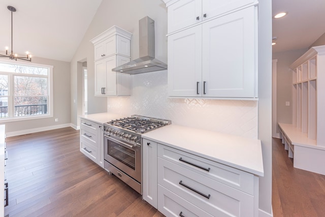 5535 W Huron River Dr, Dexter, MI 48130 - kitchen with wall chimney exhaust hood, high end stainless steel range oven, dark wood-style flooring, tasteful backsplash, and a chandelier
