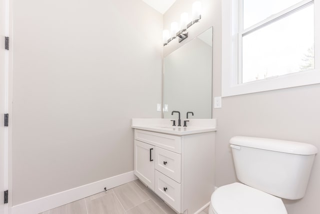 5535 W Huron River Dr, Dexter, MI 48130 - bathroom featuring vanity, toilet, and baseboards