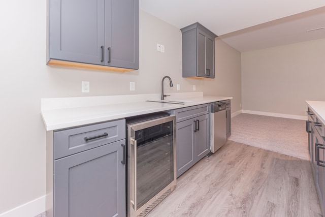 5535 W Huron River Dr, Dexter, MI 48130 - kitchen with beverage cooler, stainless steel dishwasher, gray cabinets, and baseboards